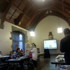 Picture of an intimate room with booths with editors from student publications 