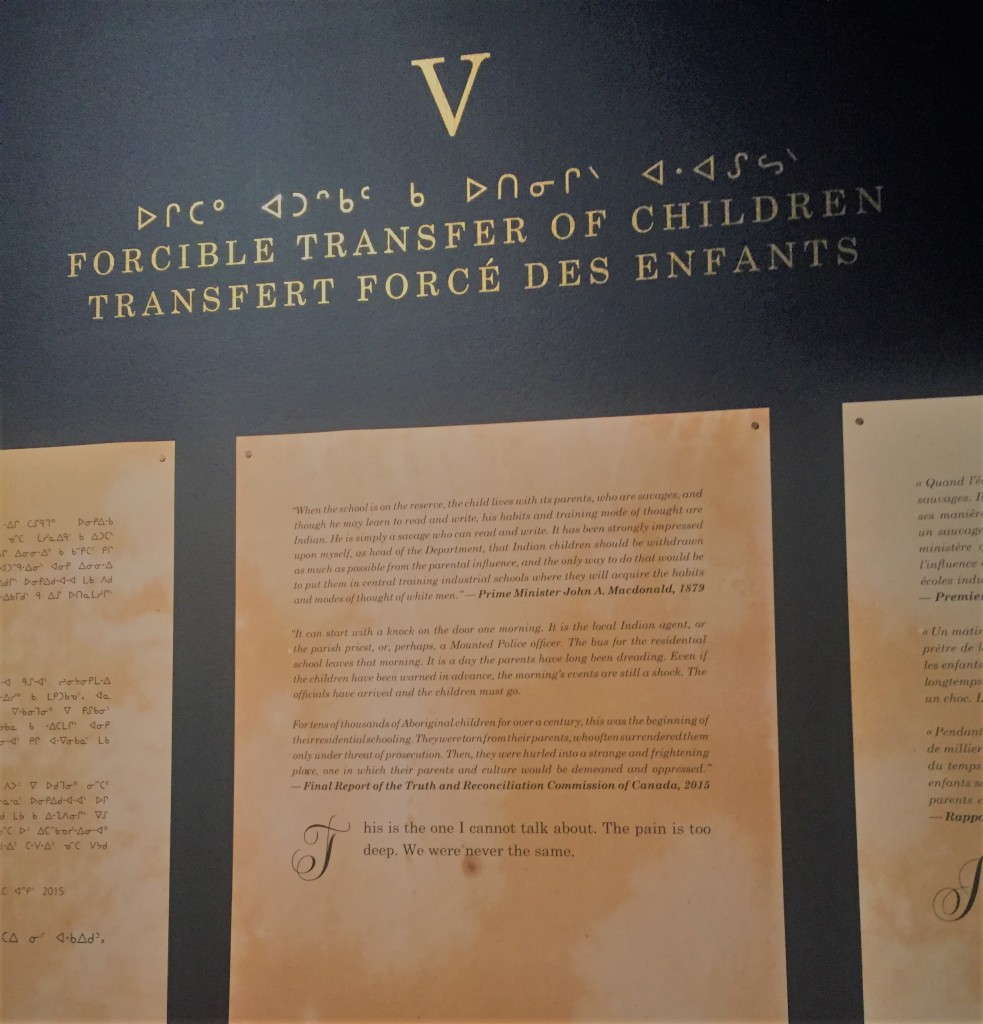 The narrative that introduces the section on Forcible Transfer of Children is displayed on the wall. At the bottom Miss Chief writes: "This is the one I cannot talk about. The pain is too deep. We were never the same."