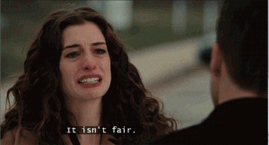 Anne Hathaway is seen in a photo from a movie saying "It isn't fair".