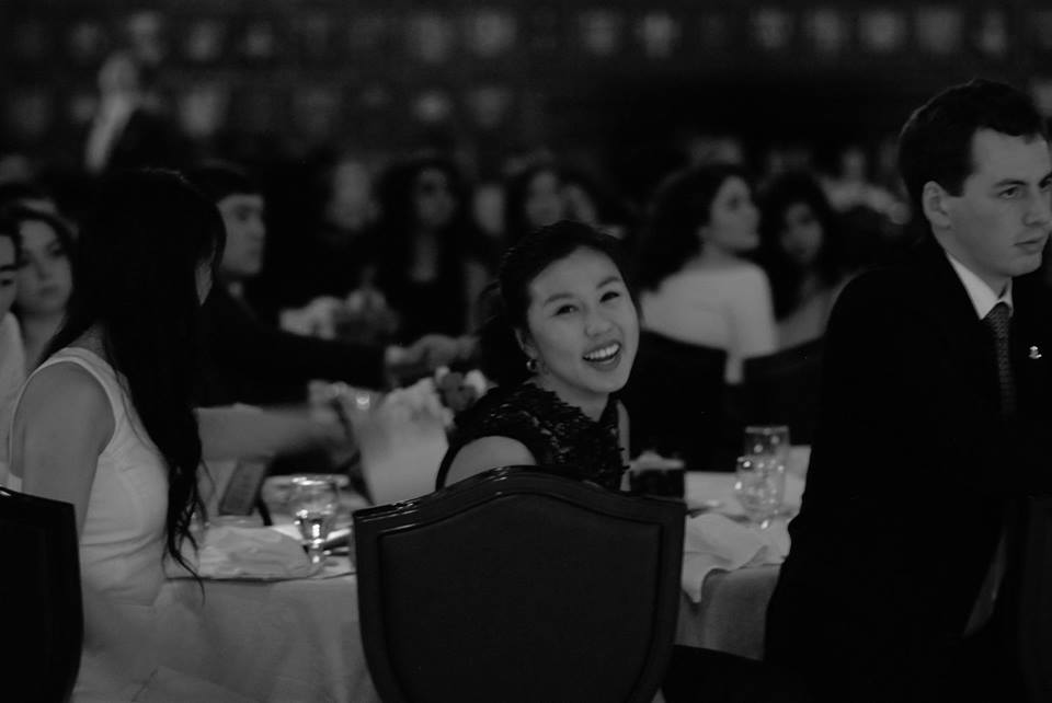 Linh sitting at a banquet table