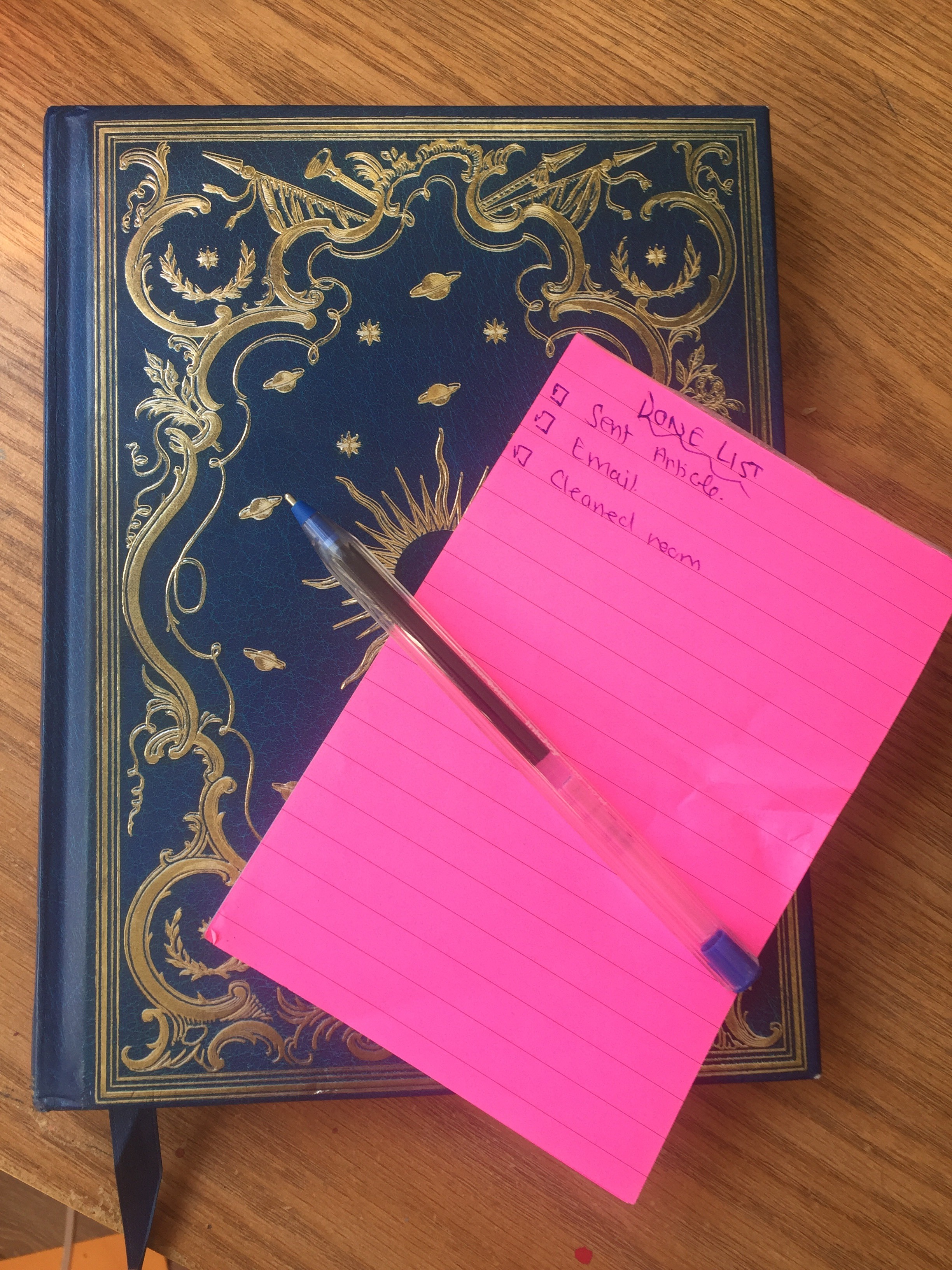 A picture of a note book and list of completed tasks.