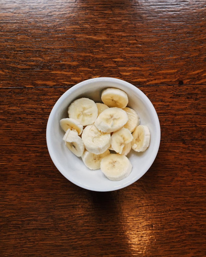 A photo of sliced bananas in a small bowl.