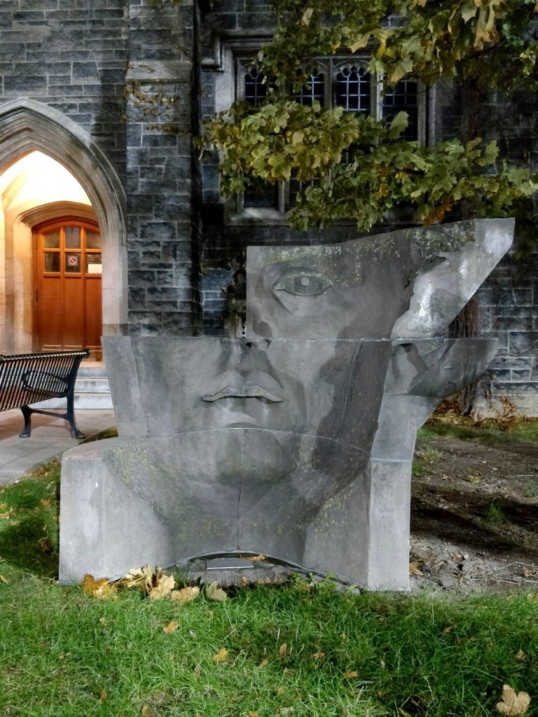 picture of the Hart House Mask sculpture which looks like a changing face from each side