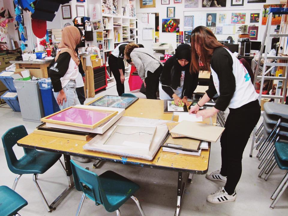 Photo of us hard at work, cleaning frames, cataloging paintings and lending a hand where needed 