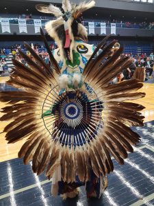 Photo of pow wow dancer with eagle feather regalia