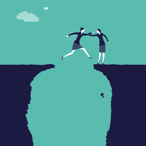 two women helping each other jump across a cliff