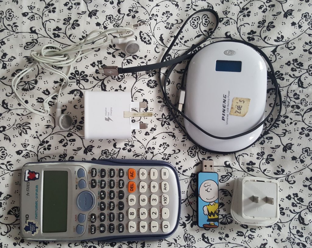 calculator, power bank, charger, phone cable and USB stick