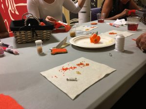 Students at the Centre for Indigenous Studies beading orange shirt pins
