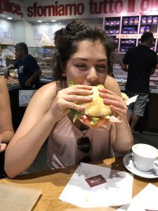 Author biting into a giant sandwich