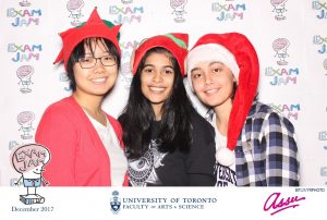 3 girls in photobooth with Christmas props