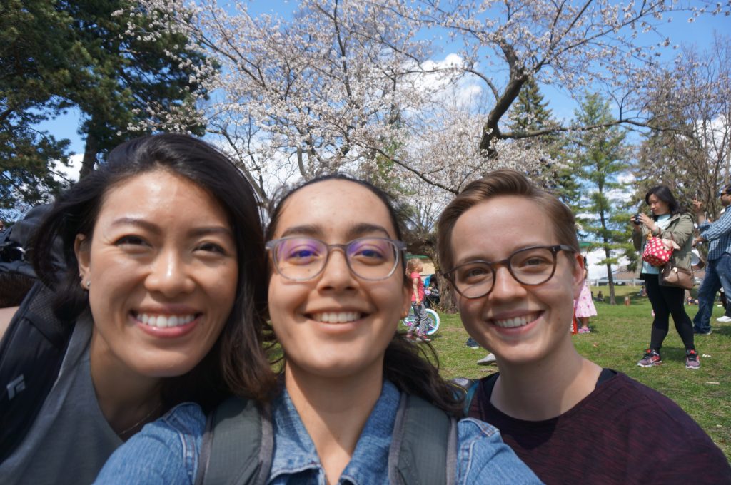 three women with cherry blossoms at high park