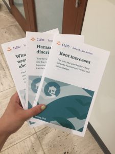 A hand holding brochures about tenant rights. 