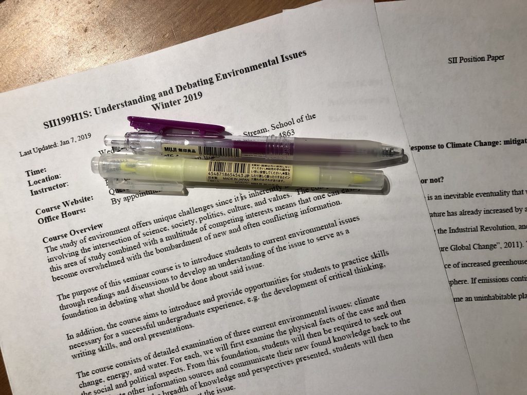 Picture of pens, SII 199 syllabus, and SII debate paper