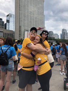 Francesca and two friends hugging at Nathan Phillip's Square during an orientation week event