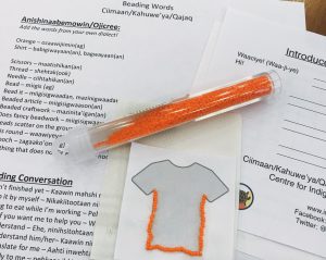Orange beaded shirt and Anishinaabemowin language exercises