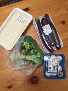 A picture of tofu, broccoli, zucchini, and mushrooms 