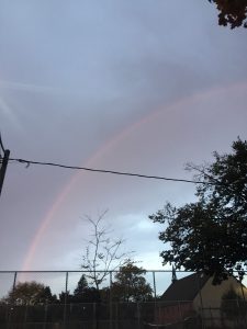 A picture of a rainbow against a purple sky