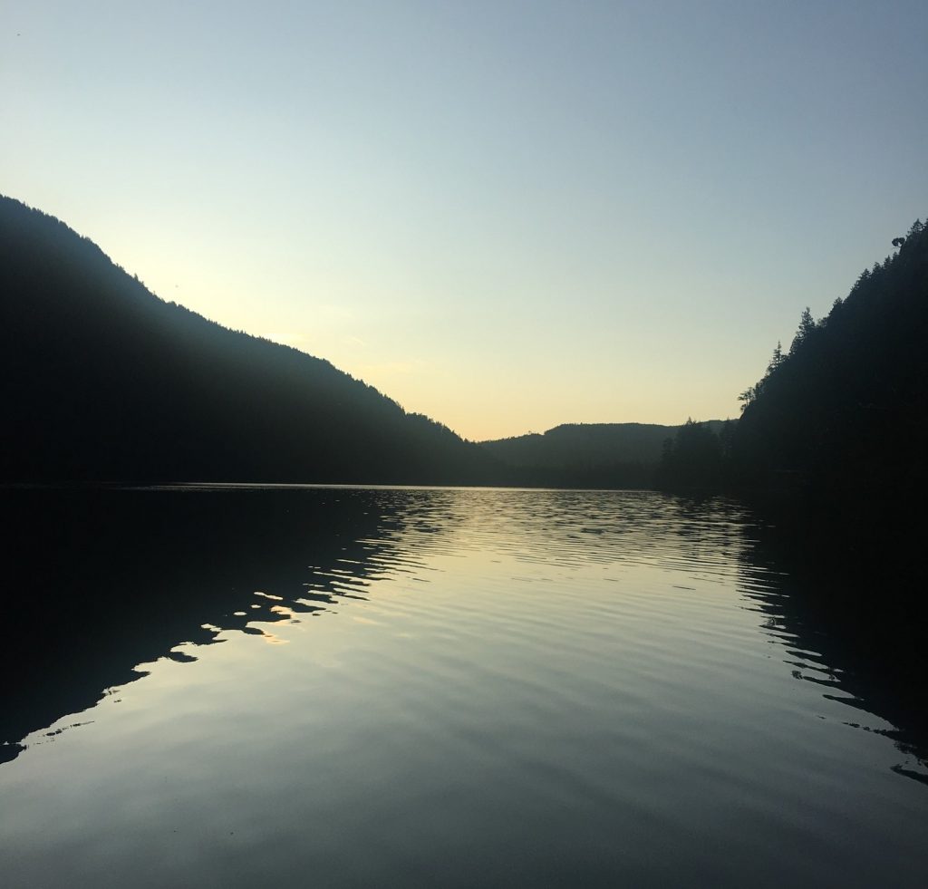 picture of a lake with two hills on either side