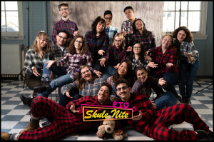 Group of students wearing flannel with "Skule Nite 2T0" logo in the bottom middle 