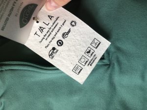 The tag on a clothing item that explains how the item is sustainable.