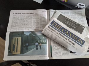 Folded "The Cannon" newspaper on top of an open newspaper