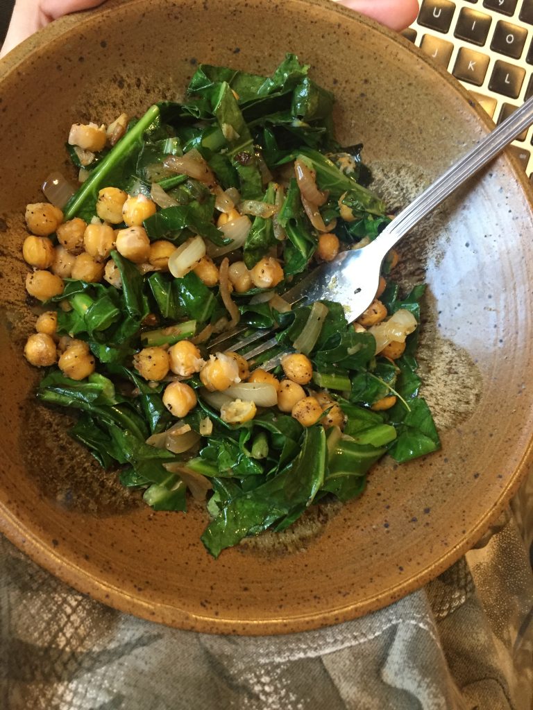 A picture of chickpeas and collard greens sautéed together
