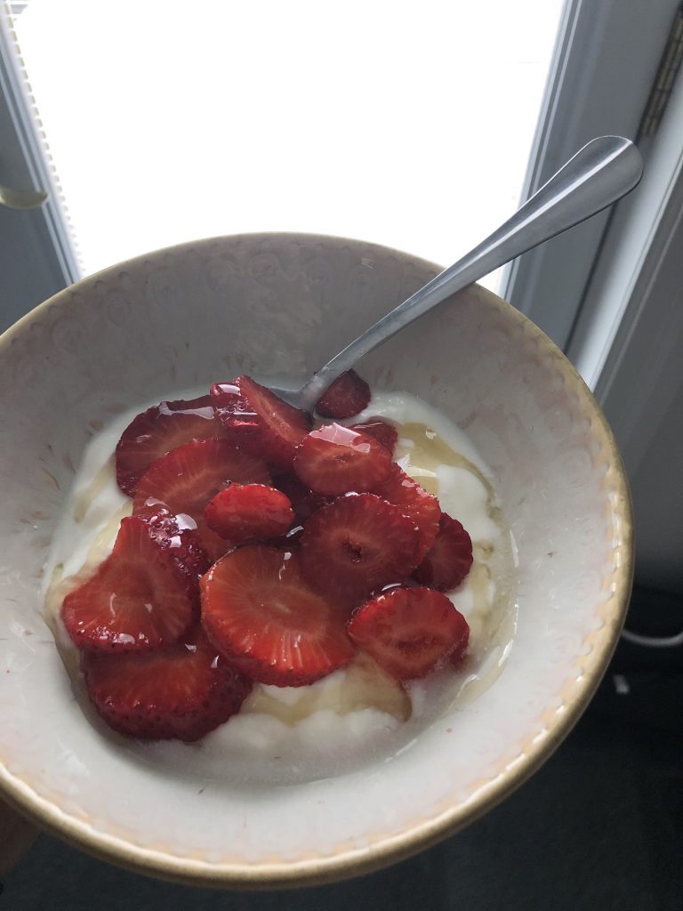Strawberries, yogurt, honey in a bowl. 