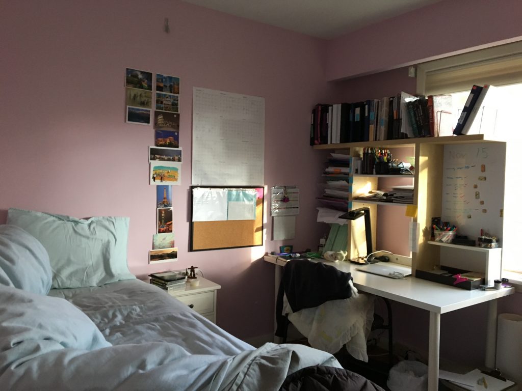 Photo of bedroom with desk filled with homework