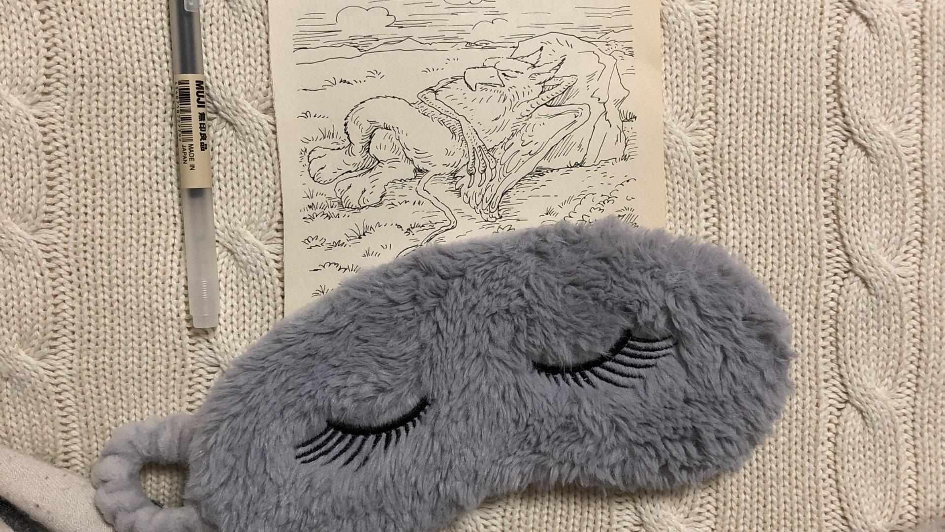 Sleep mask and image of sleeping griffin from Alice in Wonderland.