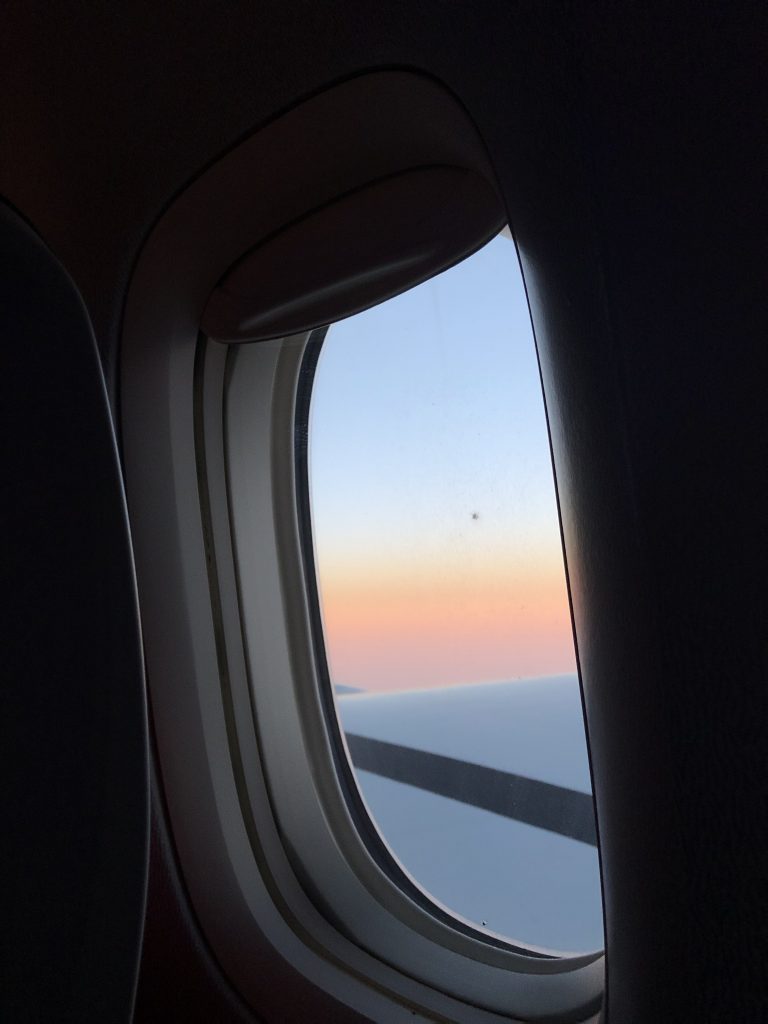Sunrise outside a plane window