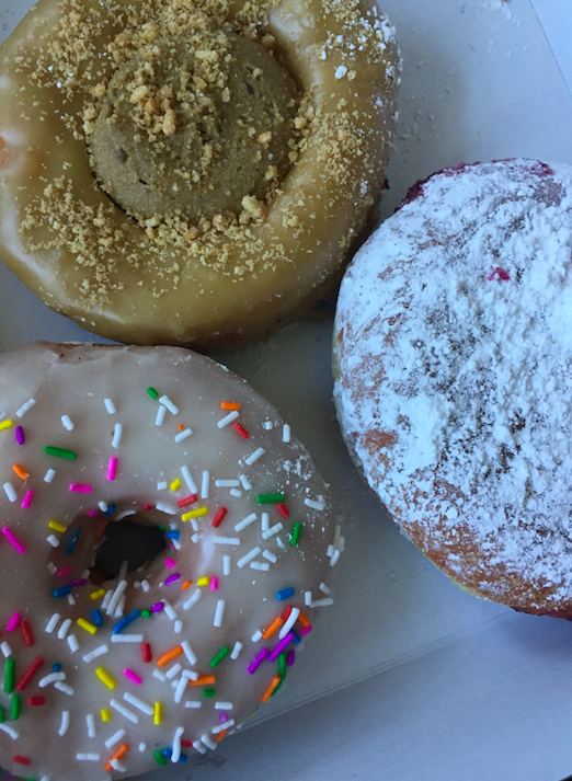 A picture of three donuts - a jelly donut, a sprinkle donut, and a butter tart donut - from Machino