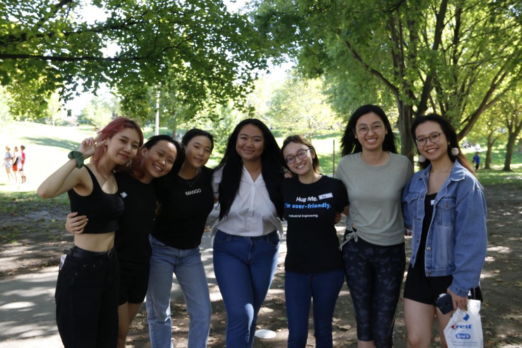 A group of 7 girls taking a picture at a park