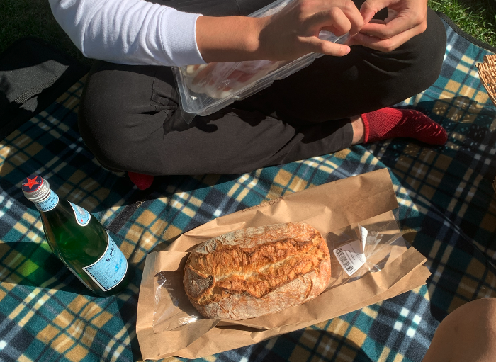 overview of a picnic set up with sparkling water and bread