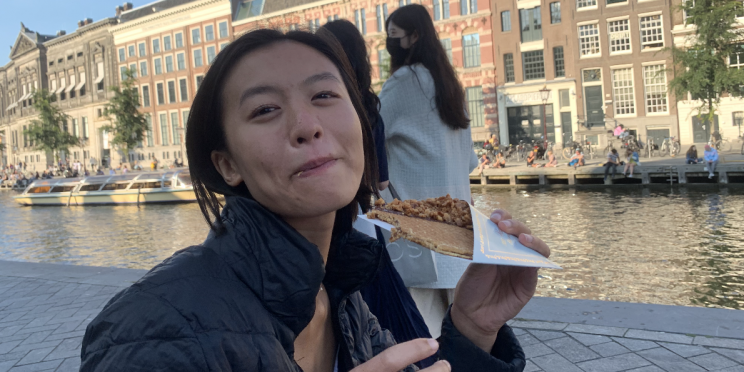 cheryl eating a waffle by the canal