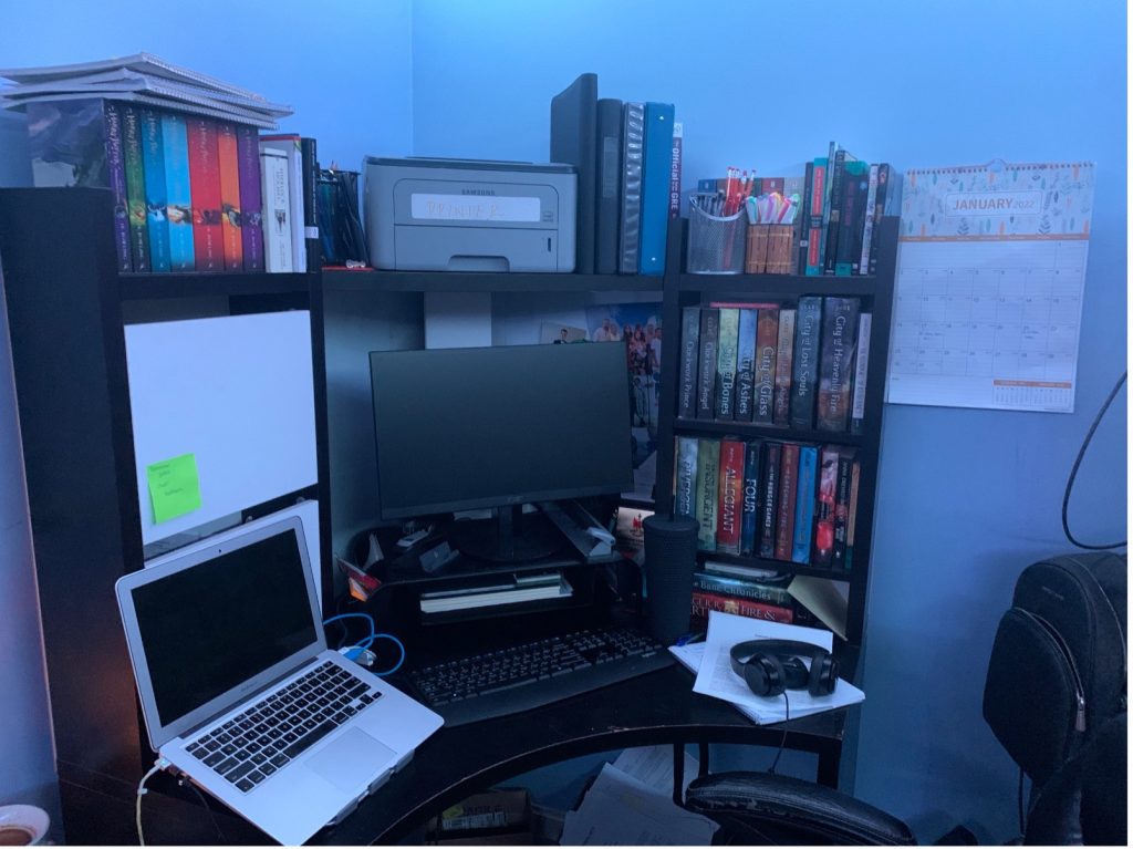 desk with computers and books