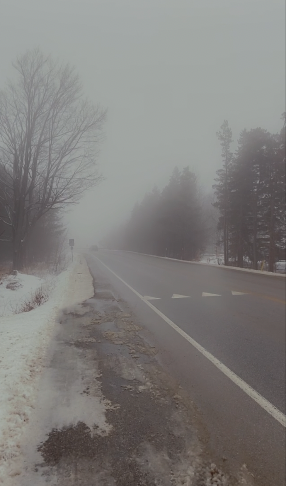 The roads at the top of the mountain covered in fog.