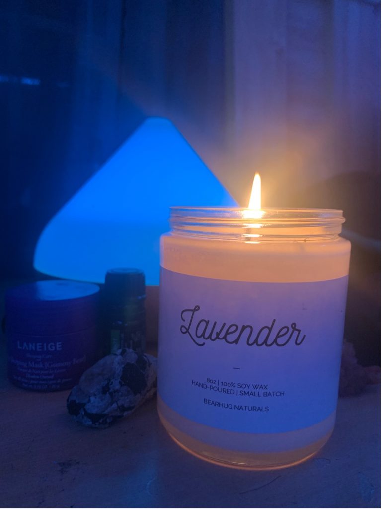 Photo of my personal nightly self-care set up; lavender candle, skincare and diffuser with essential oils 