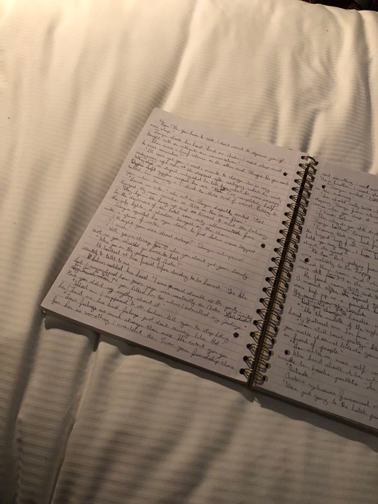 Notebook with writing on bed