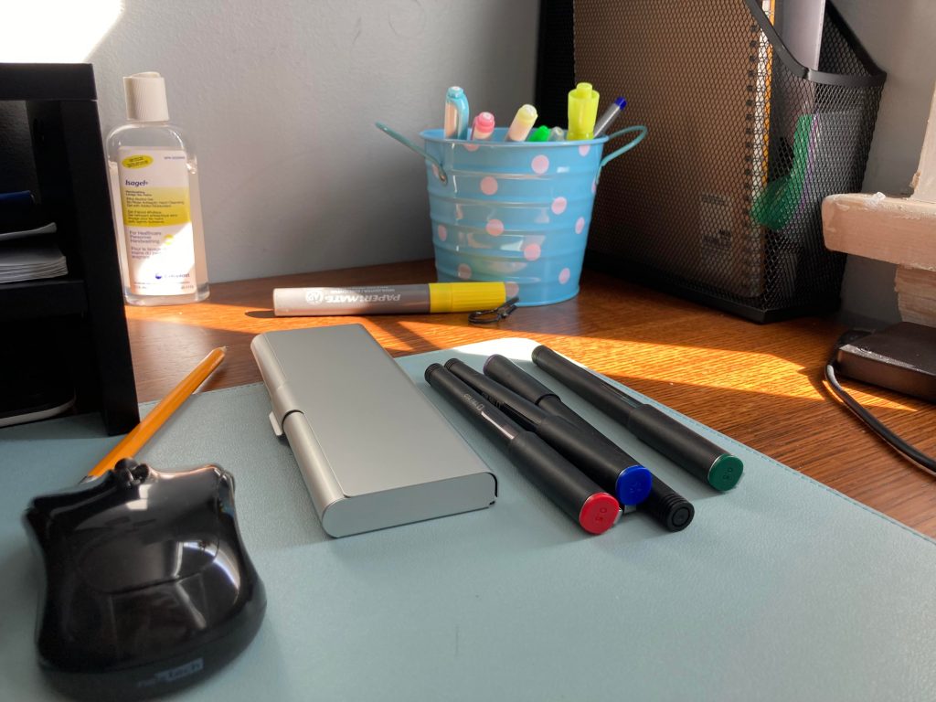 pens, highlighters and mouse on desk