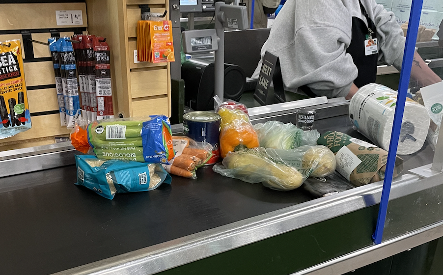 vegetables on a conveyor belt at checkout