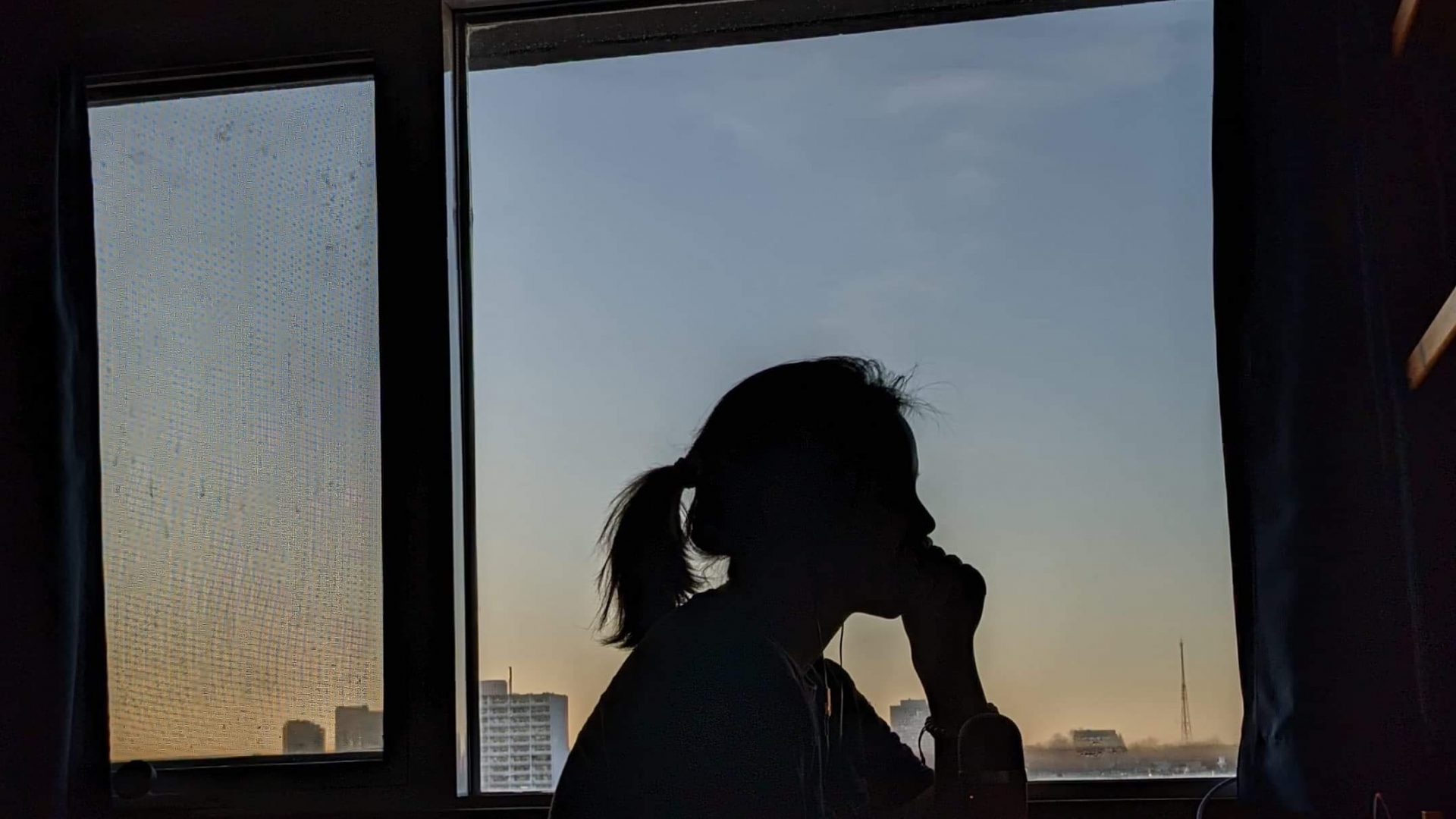 silhouette of girl studying at desk