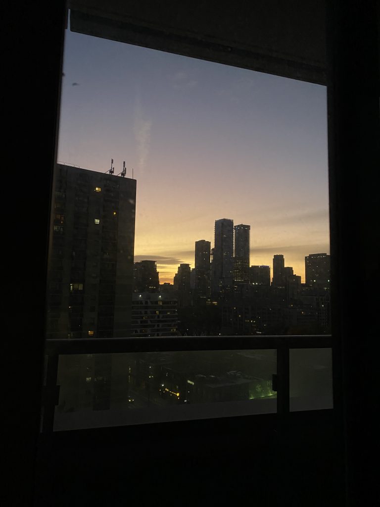 image of the sunrise seen from the window of a condo building
