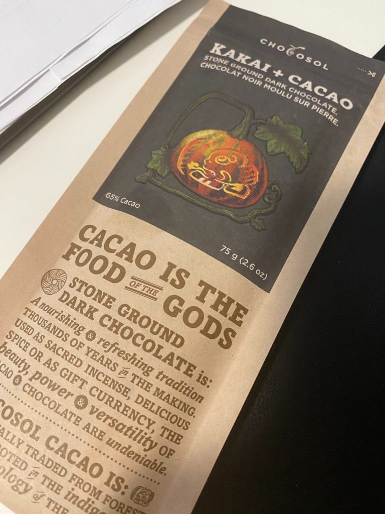 A brown chocolate bar packaging that reads "Cacao is the food of the Gods"