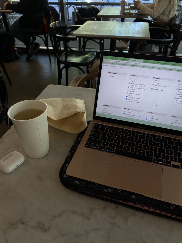 image of a cafe table with a laptop: open to a Notion page