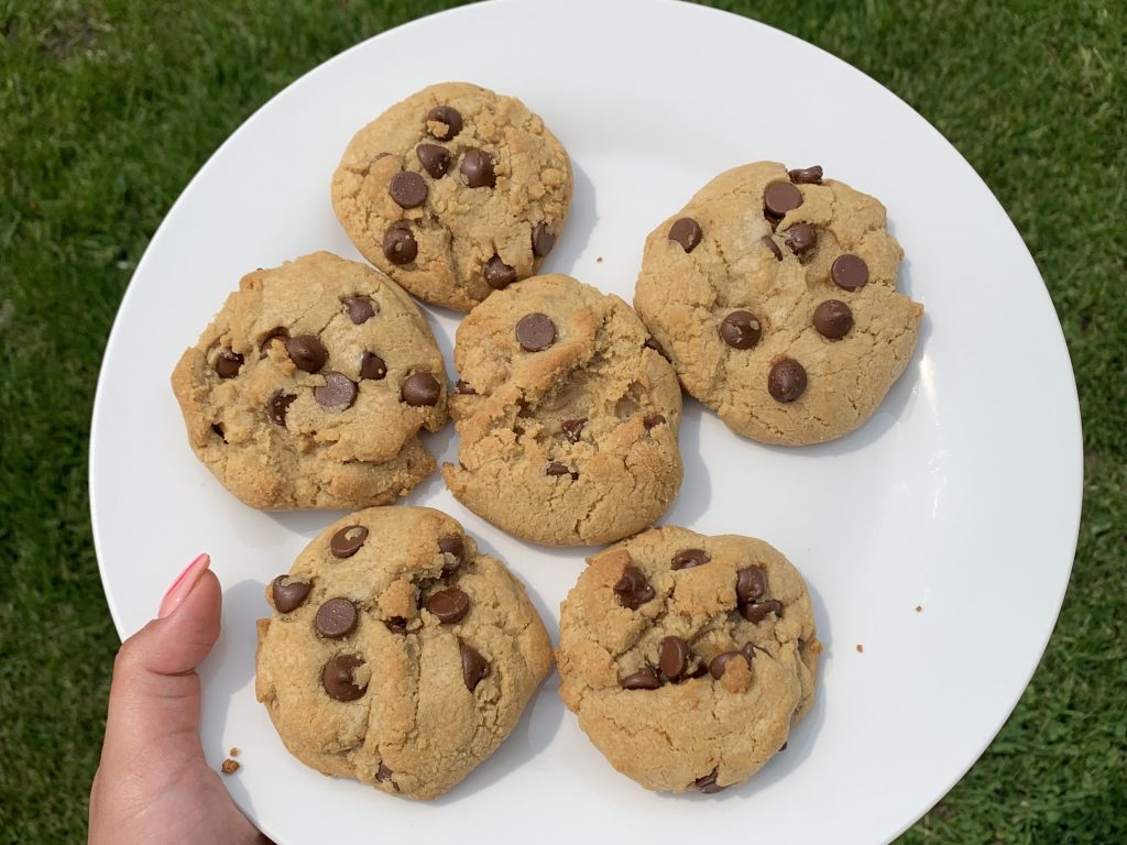 Chocolate chip cookies plated on a white plate.