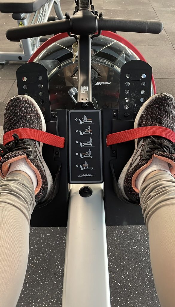 Photo of a rowing machine and a person's legs