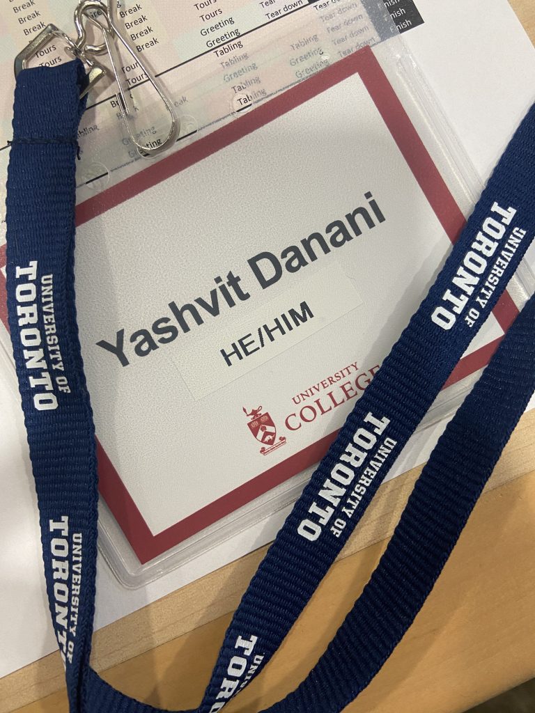 Photo of a nametag and University of Toronto lanyard with text: "Yashvit Danani / He/Him / University College"