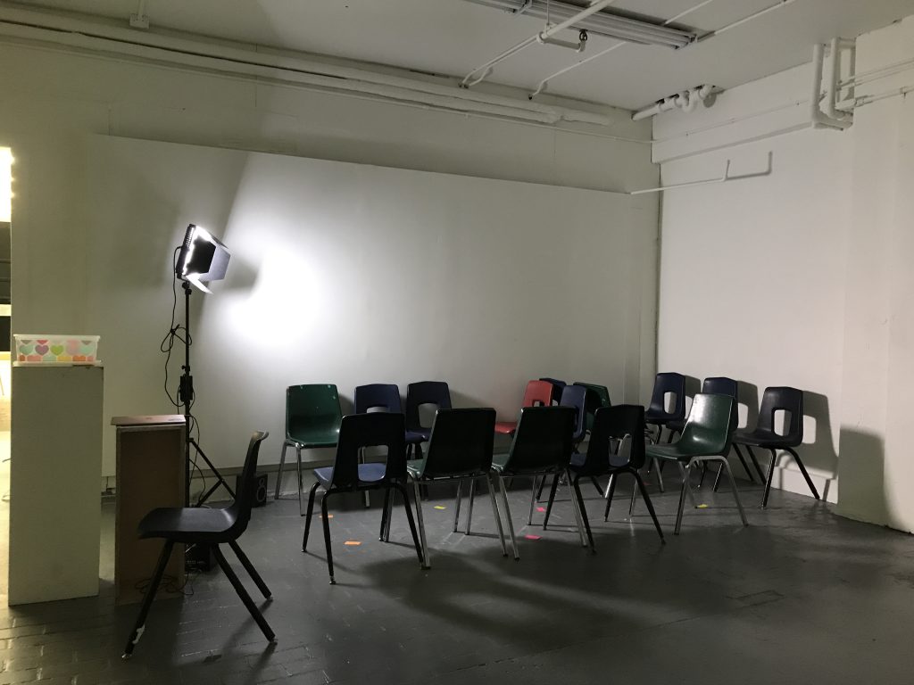 Photo of chairs set up close together in installation