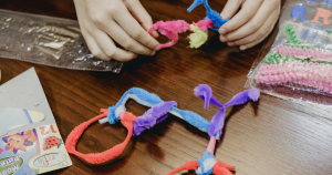 Hands working with pipe cleaners