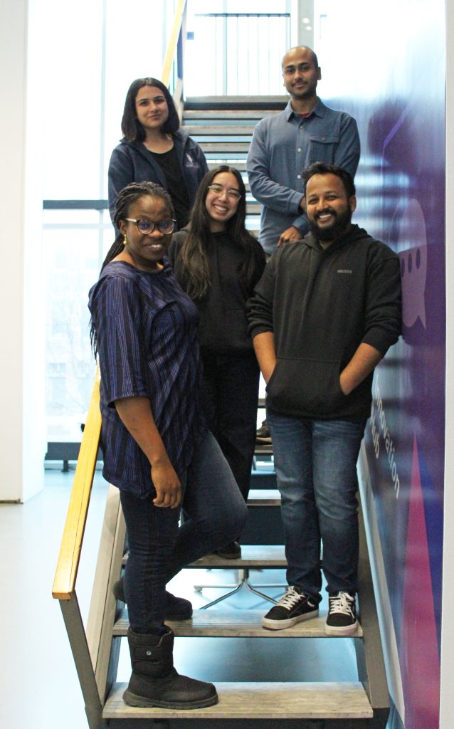 Team photo of the Experiences of Students Who Are Also Parents Design Research team. 5 people standing on a staircase.